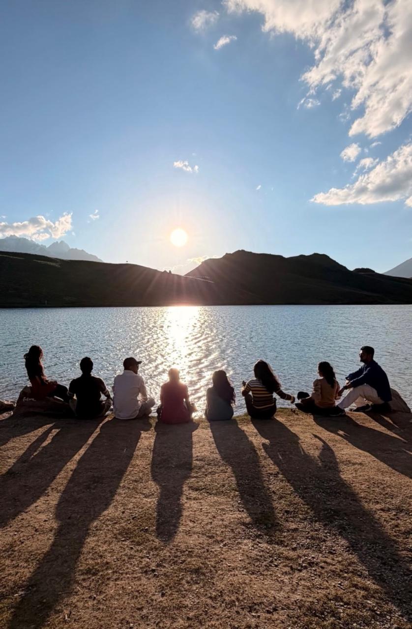 Chale Phir Se group sitting by a Spiti Valley lake at sunset